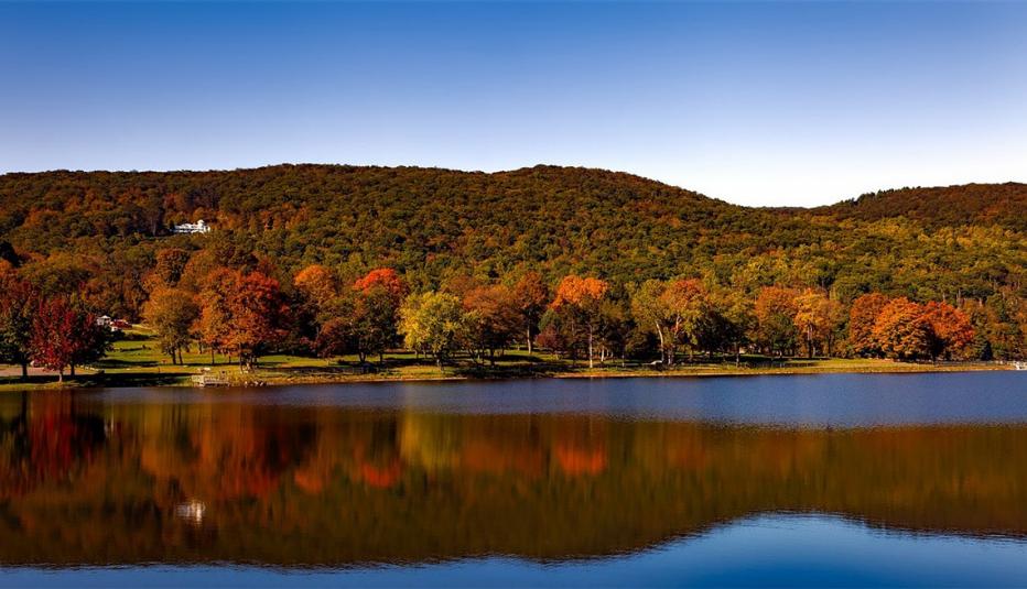 view of body of water in Connecticut with autumn foliage in background